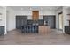 Modern kitchen with stainless steel appliances, a large island, and sleek gray cabinetry at 1 Costa Del Sol Ct, Henderson, NV 89011