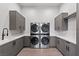 Well-organized laundry room with modern washer and dryer, ample storage, and counter space at 1 Costa Del Sol Ct, Henderson, NV 89011