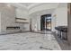 Spacious living area featuring a stone fireplace, modern art, and wet bar, ideal for entertaining guests at 1 Costa Del Sol Ct, Henderson, NV 89011