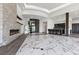 Open-concept living space boasts marble floors, a linear fireplace, and a bar, providing an elegant and airy ambiance at 1 Costa Del Sol Ct, Henderson, NV 89011
