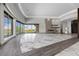 Bright and airy living space showcasing floor-to-ceiling windows, marble flooring, and a modern fireplace at 1 Costa Del Sol Ct, Henderson, NV 89011