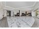 Spacious open-plan living area with marble floors, two wet bars, and seamless access to outdoor space at 1 Costa Del Sol Ct, Henderson, NV 89011