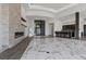 Wide angle view of a living room with fireplace, wet bar, and marble flooring at 1 Costa Del Sol Ct, Henderson, NV 89011