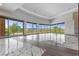 Spacious open-concept living area with tile floors and expansive glass windows and desert views at 1 Costa Del Sol Ct, Henderson, NV 89011