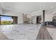 Expansive living room with marble floors, fireplace, modern wet bar, and access to the outdoor area at 1 Costa Del Sol Ct, Henderson, NV 89011