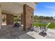 Covered outdoor patio featuring stone pillars, elegant seating, and a view of the refreshing pool area at 1 Costa Del Sol Ct, Henderson, NV 89011