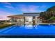 An inviting pool area with lush turf and modern architecture creates a private outdoor retreat at 1 Costa Del Sol Ct, Henderson, NV 89011