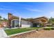 Beautiful backyard features a manicured lawn, stone patio, and luxurious architectural style at 1 Costa Del Sol Ct, Henderson, NV 89011