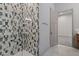 Sleek shower featuring black and white tiles and a glass door, leading to another room at 1 Costa Del Sol Ct, Henderson, NV 89011