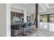 Modern wet bar area with counter seating, dark wood accents, and a view of the backyard at 1 Costa Del Sol Ct, Henderson, NV 89011