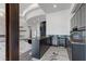 Contemporary wet bar featuring dark cabinetry, a wine fridge, and marble countertops, perfect for entertaining guests at 1 Costa Del Sol Ct, Henderson, NV 89011