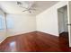 This bedroom features laminate wood floors, a ceiling fan, and closet space at 10381 Poker Alice Ct, Las Vegas, NV 89129