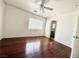 Bright, spacious bedroom with hardwood floors, ceiling fan, and ample natural light from a large window at 10381 Poker Alice Ct, Las Vegas, NV 89129