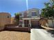 Two-story home with a two-car garage, featuring a well-kept front yard at 10381 Poker Alice Ct, Las Vegas, NV 89129