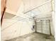 Spacious garage featuring overhead storage racks and a secure, paneled garage door at 10381 Poker Alice Ct, Las Vegas, NV 89129