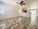 Open-concept living area leading to the kitchen, featuring tile flooring and lots of light at 10381 Poker Alice Ct, Las Vegas, NV 89129