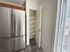 A large walk-in pantry with ample shelving space, located adjacent to the stainless refrigerator at 10381 Poker Alice Ct, Las Vegas, NV 89129