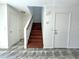Wood stairway in the foyer with access to an upstairs landing at 10381 Poker Alice Ct, Las Vegas, NV 89129