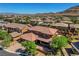 Stunning aerial perspective showcasing a home with a tile roof, lush landscaping, and neighborhood setting at 10433 Ember Rose Ave, Las Vegas, NV 89135