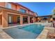 Expansive backyard featuring a sparkling pool, patio, outdoor kitchen, and lush garden, ideal for relaxation at 10433 Ember Rose Ave, Las Vegas, NV 89135