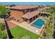 Aerial view showcasing a backyard oasis with a pool, lounge area, and artificial grass at 10433 Ember Rose Ave, Las Vegas, NV 89135
