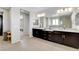Bathroom with dual sink vanity, modern fixtures, and walk-in shower with glass door at 10433 Ember Rose Ave, Las Vegas, NV 89135