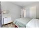 Cozy bedroom with wood look tile floors, stylish dresser, and warm lighting at 10433 Ember Rose Ave, Las Vegas, NV 89135