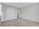 This spacious bedroom features a neutral color scheme, with large double closets for ample storage and soft carpeting at 10433 Ember Rose Ave, Las Vegas, NV 89135
