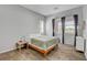 Bright bedroom showcasing natural light, wood look tile floors, and neutral decor for relaxation at 10433 Ember Rose Ave, Las Vegas, NV 89135