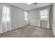 Bright bedroom with dual windows adorned with white curtains, offering natural light and a serene view at 10433 Ember Rose Ave, Las Vegas, NV 89135
