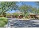 Gated entrance to a residential community with mature trees and professional landscaping at 10433 Ember Rose Ave, Las Vegas, NV 89135
