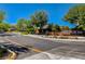 Street-level view of the Monte Bello community entrance sign surrounded by mature landscaping at 10433 Ember Rose Ave, Las Vegas, NV 89135