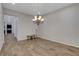 Spacious dining room with a decorative chandelier and hardwood floors throughout at 10433 Ember Rose Ave, Las Vegas, NV 89135