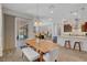 Bright dining area connects to the kitchen and living room, featuring a wood table and access to the patio at 10433 Ember Rose Ave, Las Vegas, NV 89135