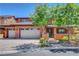 Inviting home exterior with a three-car garage, terracotta accents, and a manicured front yard at 10433 Ember Rose Ave, Las Vegas, NV 89135