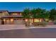 Charming home exterior featuring a three-car garage, brick accents, and a well-manicured front yard at 10433 Ember Rose Ave, Las Vegas, NV 89135