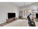 Modern home office with a large window, a sleek desk setup, and a comfortable ergonomic chair at 10433 Ember Rose Ave, Las Vegas, NV 89135