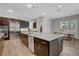 Spacious kitchen with stainless steel appliances, large island, and modern pendant lighting at 10433 Ember Rose Ave, Las Vegas, NV 89135