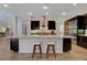 Bright kitchen with a large island, pendant lighting, and stainless steel appliances at 10433 Ember Rose Ave, Las Vegas, NV 89135