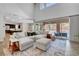Open-concept living room with a large sectional, flowing seamlessly into the kitchen at 10433 Ember Rose Ave, Las Vegas, NV 89135
