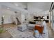 Spacious living area with soaring ceilings, staircase, and connection to the kitchen at 10433 Ember Rose Ave, Las Vegas, NV 89135