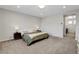 Neutral main bedroom with carpeted floor and ensuite bathroom entrance at 10433 Ember Rose Ave, Las Vegas, NV 89135