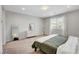 Calm main bedroom featuring a large window, soft carpeting, and contemporary decor at 10433 Ember Rose Ave, Las Vegas, NV 89135