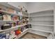 Walk-in pantry with ample shelving for storage of food and kitchen supplies at 10433 Ember Rose Ave, Las Vegas, NV 89135