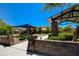 Inviting park entrance featuring stone pillars, covered seating areas, and well-maintained landscaping at 10433 Ember Rose Ave, Las Vegas, NV 89135