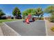 Community playground with colorful slides, climbing structures, and soft ground cover, designed for fun and safety at 10433 Ember Rose Ave, Las Vegas, NV 89135