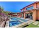 Inviting backyard features a pool, spa, patio, mountain views and a landscaped retaining wall, creating an oasis at 10433 Ember Rose Ave, Las Vegas, NV 89135