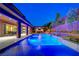 Stunning backyard with a luxurious pool, swim up bar, and lounge area, perfect for entertaining at 10433 Ember Rose Ave, Las Vegas, NV 89135