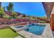 Inviting pool and spa with manicured terraced landscaping create a serene and private backyard oasis at 10433 Ember Rose Ave, Las Vegas, NV 89135