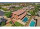 Beautiful aerial view of a home's backyard with a pool, spa, covered patio, and well-maintained landscaping at 10433 Ember Rose Ave, Las Vegas, NV 89135